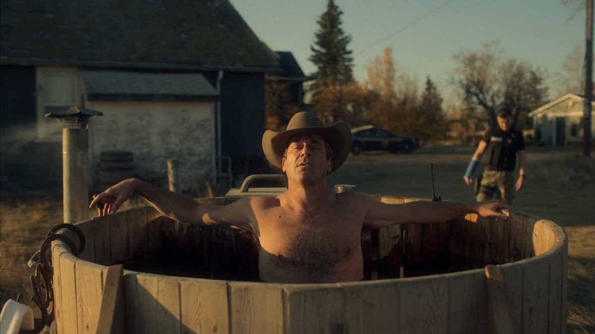 Jon Hamm wearing a cowboy hat sitting in a hot tub in a scene from Fargo