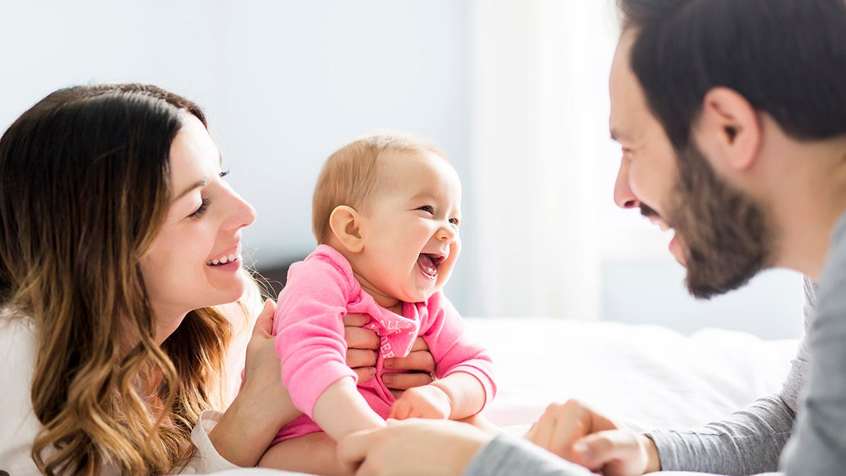 parents laughing with baby