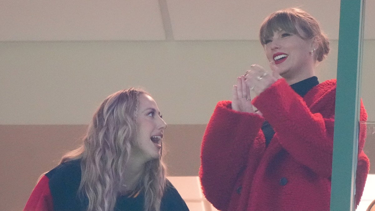 Taylor Swift wore her signature red lips and a matching coat in Green Bay Wisconsin